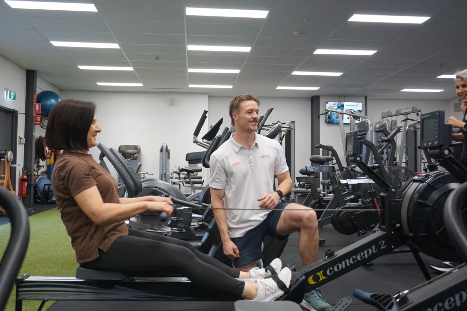 Physio Semaphore session at Inertia Health Group, where a physiotherapist guides a client through exercise-based physiotherapy in a modern rehabilitation gym to improve strength, mobility, and recovery.