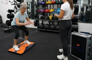 Elderly woman performing a balance exercise to improve stability and mobility